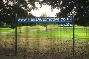 outdoor sign mounted on a fence