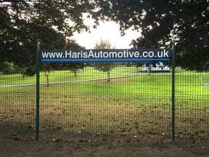 outdoor sign mounted on a fence