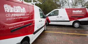 pair of city response vans with branded graphics