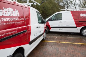 pair of city response vans with branded graphics