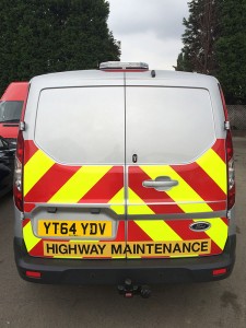 reflective safety chevrons on the back of a highway maintenance van