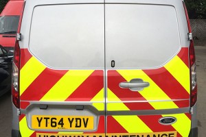 reflective safety chevrons on the back of a highway maintenance van