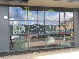 Photographic example of window graphics used as an outdoor sign to promote the business